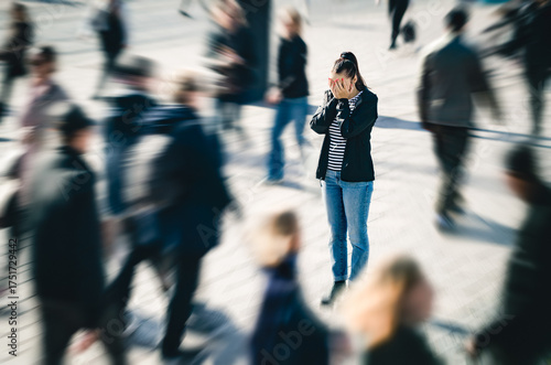 Stress, anxiety, fear or panic attack in public. Depressed woman with mental health disorder or schizophrenia. Phobia of crowd of people. Introvert person in busy city street. Agoraphobia or paranoia.