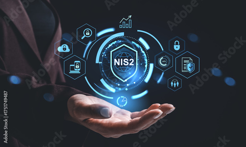 Futuristic NIS2 cybersecurity hologram interface concept above an open hand with digital padlock icons and data protection symbols glowing in blue.