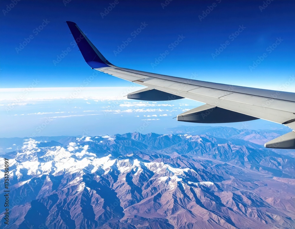 Obraz premium Airplane Wing Over Majestic Mountain Range