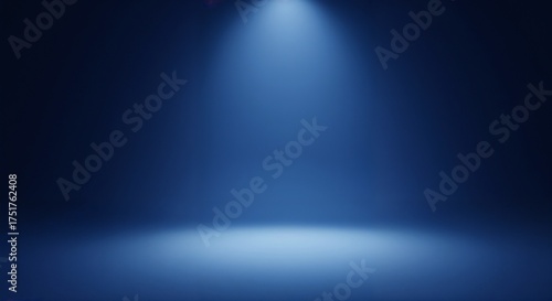 Spotlight casting a cool blue glow on an empty stage creating a dramatic atmosphere for performance or artistic display