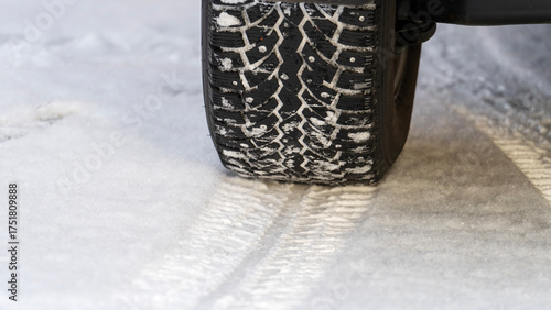 Car on winter tires on snow. Winter tyre tread on snow