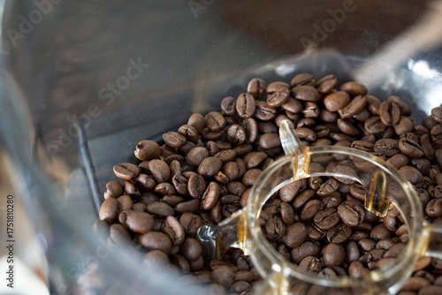 Top view of coffee bean in grinder hopper.      