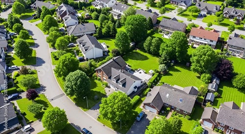 Overhead view of a green suburban neighborhood with wellmaintained houses, lush trees, and manicured lawns animated 4k video