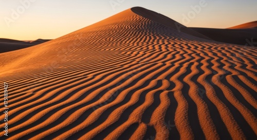 Fototapeta Naklejka Na Ścianę i Meble -  Sunlit sand dunes with ripples in the sand at sunset.