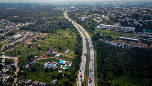 Arial shot of Beautiful road infrastructure of karnataka in India. Aerial view city traffic Highway road with car vehicle movement