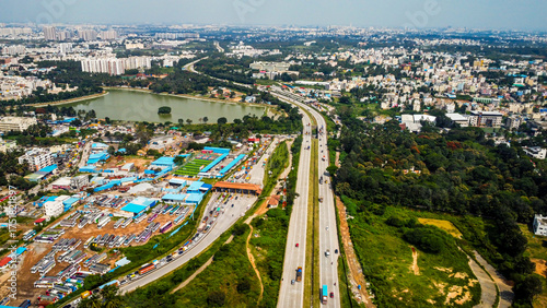 Arial shot of Beautiful road infrastructure of karnataka in India. Aerial view city traffic Highway road with car vehicle movement