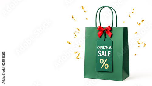 Green Christmas Sale Bag With Red Bow And Tag On White Background. Concept Of Holiday Shopping, Seasonal Discounts, Gift Packaging, Christmas Retail Promotion, And Winter Sale Advertising