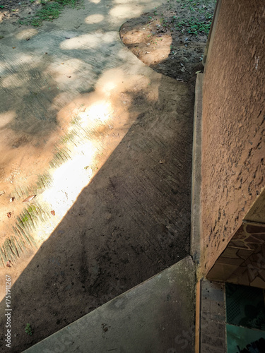Brick wall architecture background under morning sky, sunlight texture reflecting on the floor, bokeh from sunlight.