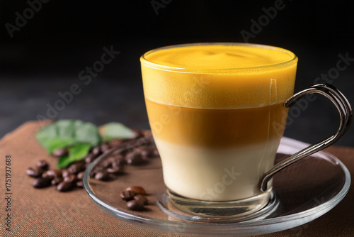 Vietnamese egg coffee with golden frothy top in elegant glass cup encouraging educational interest and inspiring cultural sustainability through culinary traditions

