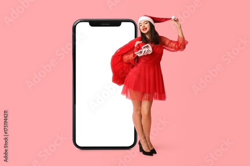 Sexy young woman in Santa c...