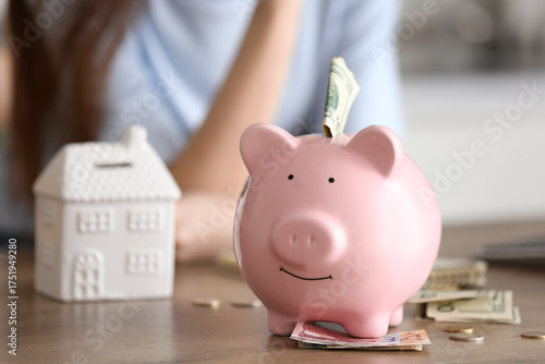 Piggy bank with money on ta...
