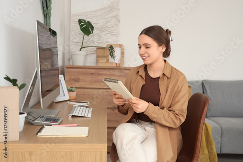 Young woman with notebook s...
