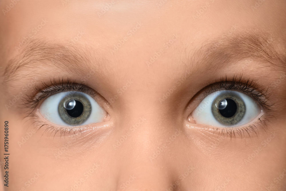 Naklejka premium Surprised little boy with green eyes, closeup