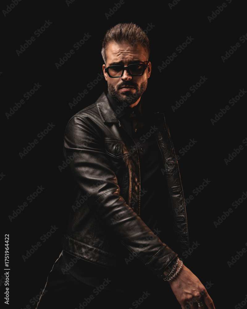 Fototapeta premium cool dramatic man with sunglasses in black leather jacket posing