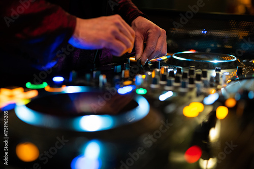 DJ hands playing music on CDJ turntable deck jog wheel nightclub party mixing live performance professional