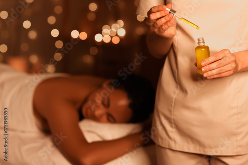 Masseur with bottle of oil ...