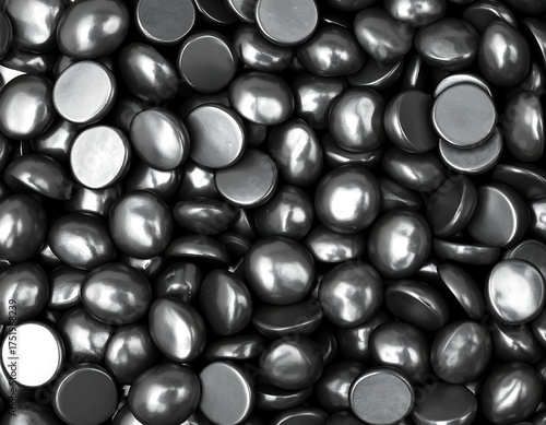 Dark gray, polished, round objects clustered closely