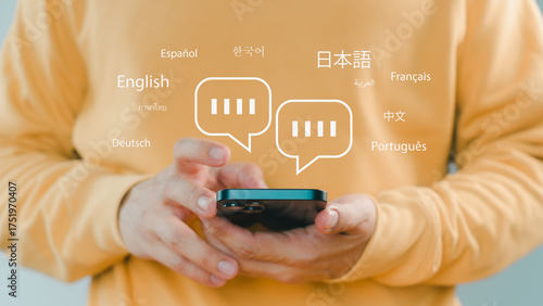 Person using smartphone with multilingual chat icons, representing global communication, language translation, online messaging, and international connection through modern mobile technology.