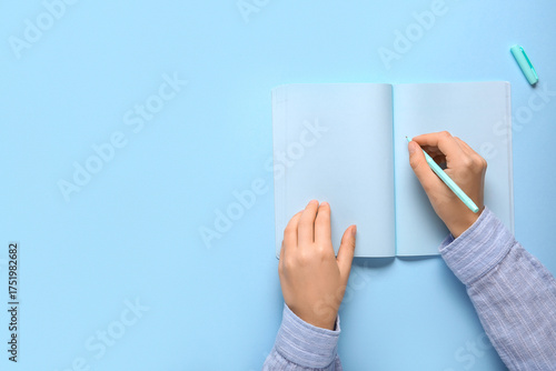 Female hands writing in not...