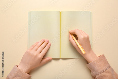 Female hands writing in not...