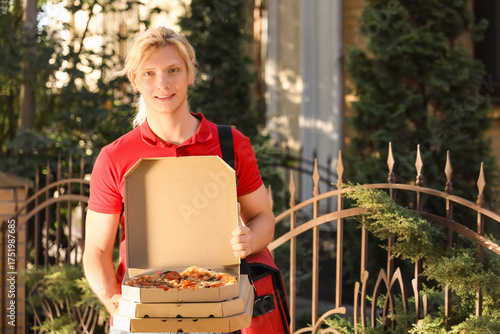 Male courier with pizza box...