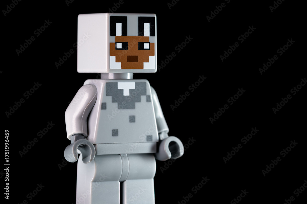 Fototapeta premium LEGO Minecraft character with rabbit face mask standing sideways on the black background