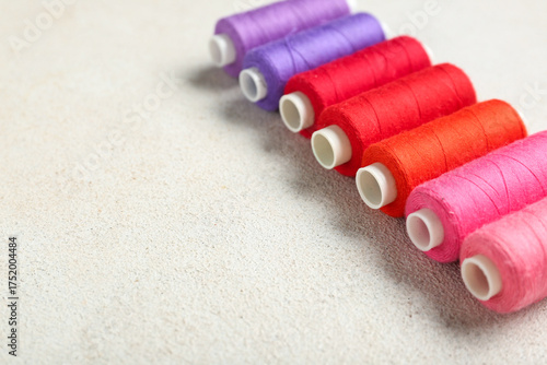 Row of colorful thread spoo...