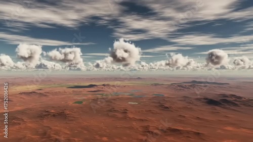 Aerial view of a vast desert landscape with scattered water bodies and dramatic cloud formations