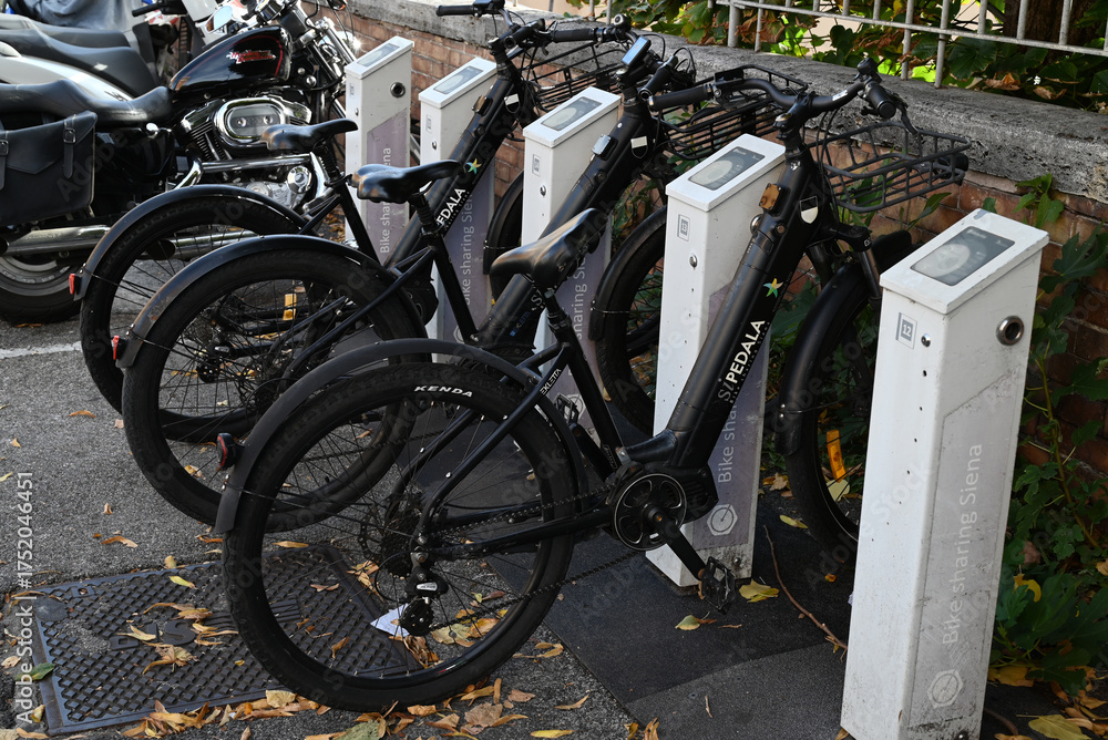 Fototapeta premium Sienne, Italie, 16 septembre 2025 : Station de vélos électriques à partager SiPedala de la ville Sienne