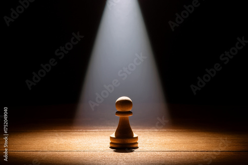 A lone pawn in light and shadow, representing the internal struggle of growth and self-discovery.
