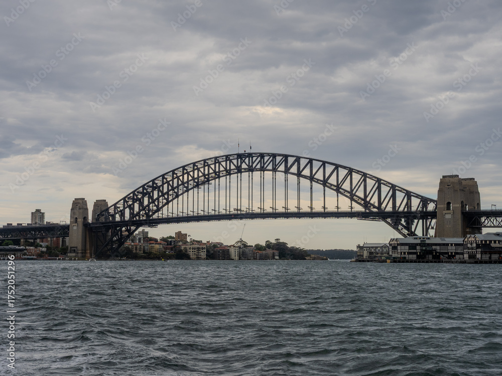 Fototapeta premium 11 October 2025 Sydney Harbour Bridge at Circular Quay on Sydney Harbour on a cloudy cool spring Day in Sydney NSW Australia