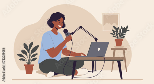 Young woman recording podcast with microphone and laptop in cozy home studio, concept for online content creation, voice over work and digital communication