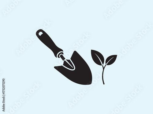 Black Silhouette of Garden Trowel with Small Plant Isolated on White Background Representing Growth
