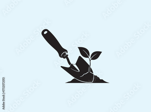 Solid Black Silhouette of Hand Trowel with Leaf Isolated on White Background Symbolizing Sustainability
