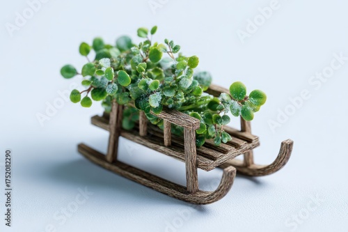 Simple wooden sled with greenery, isolated on white background, small and delicate, miniature size, presented in a cute and festive style.