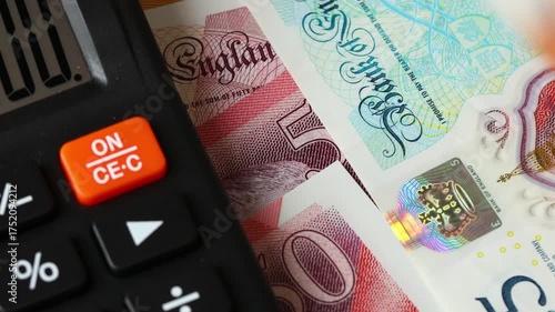  United Kingdom finances. Calculator and money counting. British pounds. UK business concept, expense analysis, taxes, cost accounting