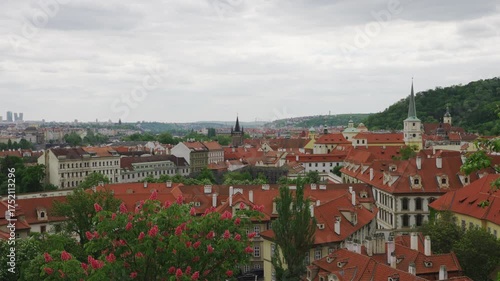 Summer cityscape of Prague with red rooftops.