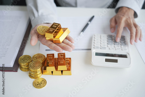 Gold Trading Businessman invest in trading gold, calculating profit price of gold in stock market when price rising 
