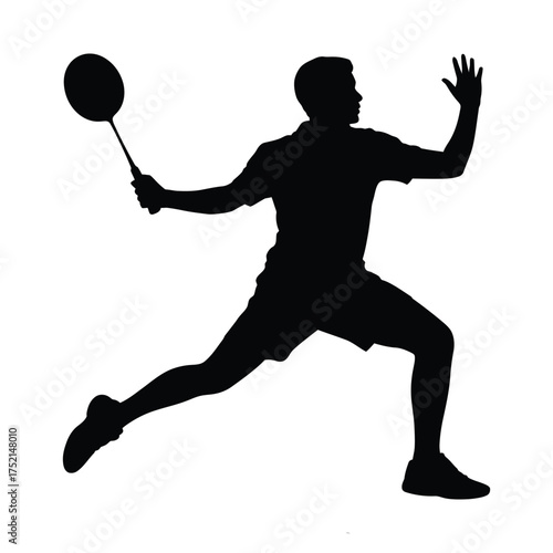 Silhouette of a male badminton player in action hitting a shuttlecock with a racket