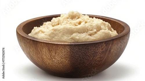 A wooden bowl filled with creamy mashed potatoes