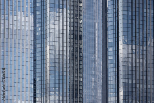 Downtown skyscrapers of same rectangular shape and size reflecting clouds on sunny day, Moscow, Russia
