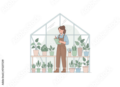 A female horticulturist or gardener standing inside a greenhouse. She is focused on taking notes on a clipboard, likely inspecting or documenting the health and progress of the plants.