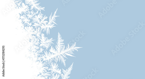 Delicate frosty ice crystals forming intricate patterns on a cold surface.