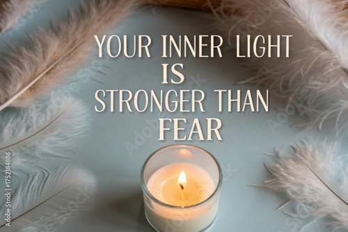 Burning Candle in Glass With Motivational Quote On Blue Surface