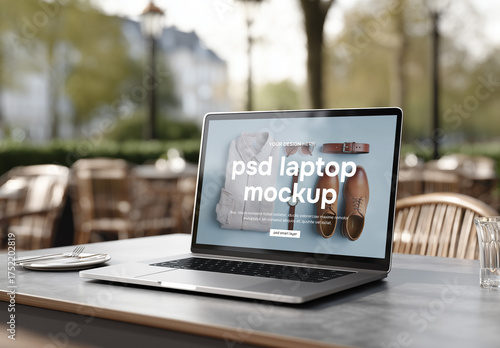 A laptop on a table at outdoor restaurant