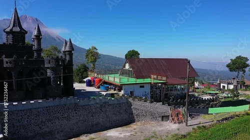 Scenic view of buildings and mountain under clear blue sky.