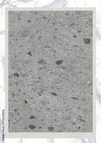 Close-up view of a speckled gray concrete surface with embedded stones and natural texture
