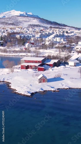Experience the breathtaking beauty of Tromso, Norway during winter. Discover the serene beaches, icy waters, and snow-capped mountains and fishing village.