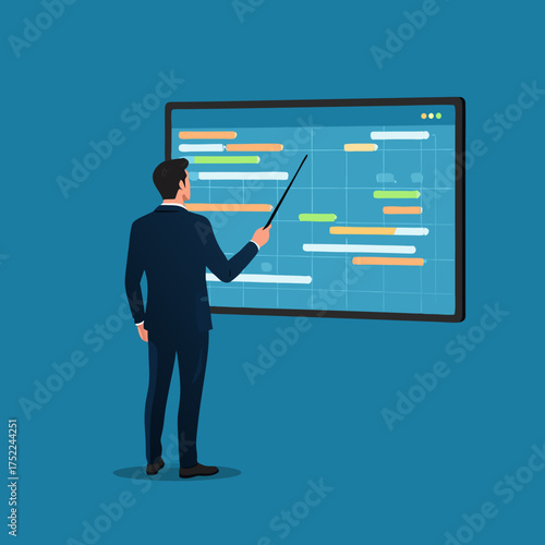 Businessman in a suit pointing at a colorful Gantt chart on a screen.