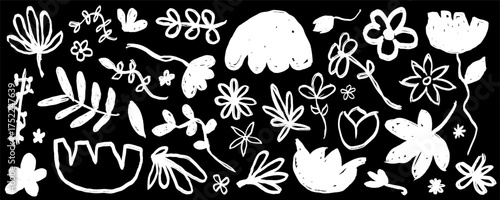 Collection of white floral doodles on a black chalkboard background. Hand-drawn monochrome set of abstract flowers and leaves in a simple, rough sketch style.